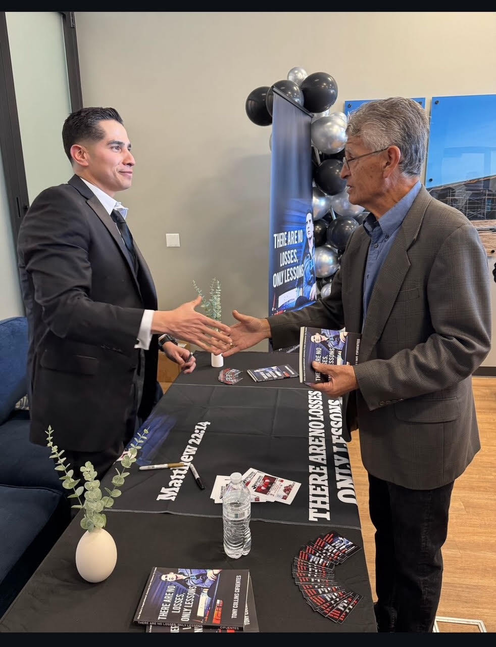 Tony Collins Cifuentes signing copies of his memoir at the public launch event