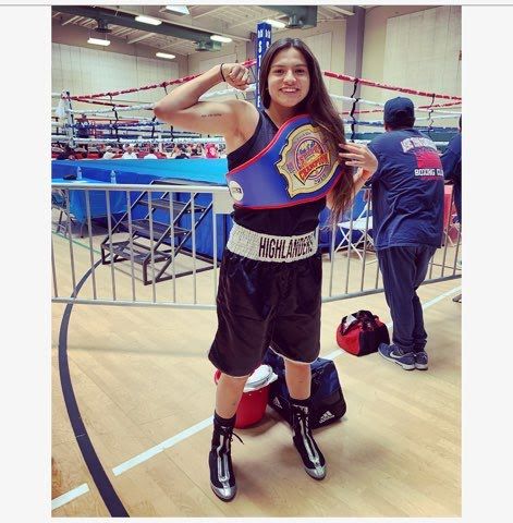 HBC athlete in the ring with a championship belt over the shoulder