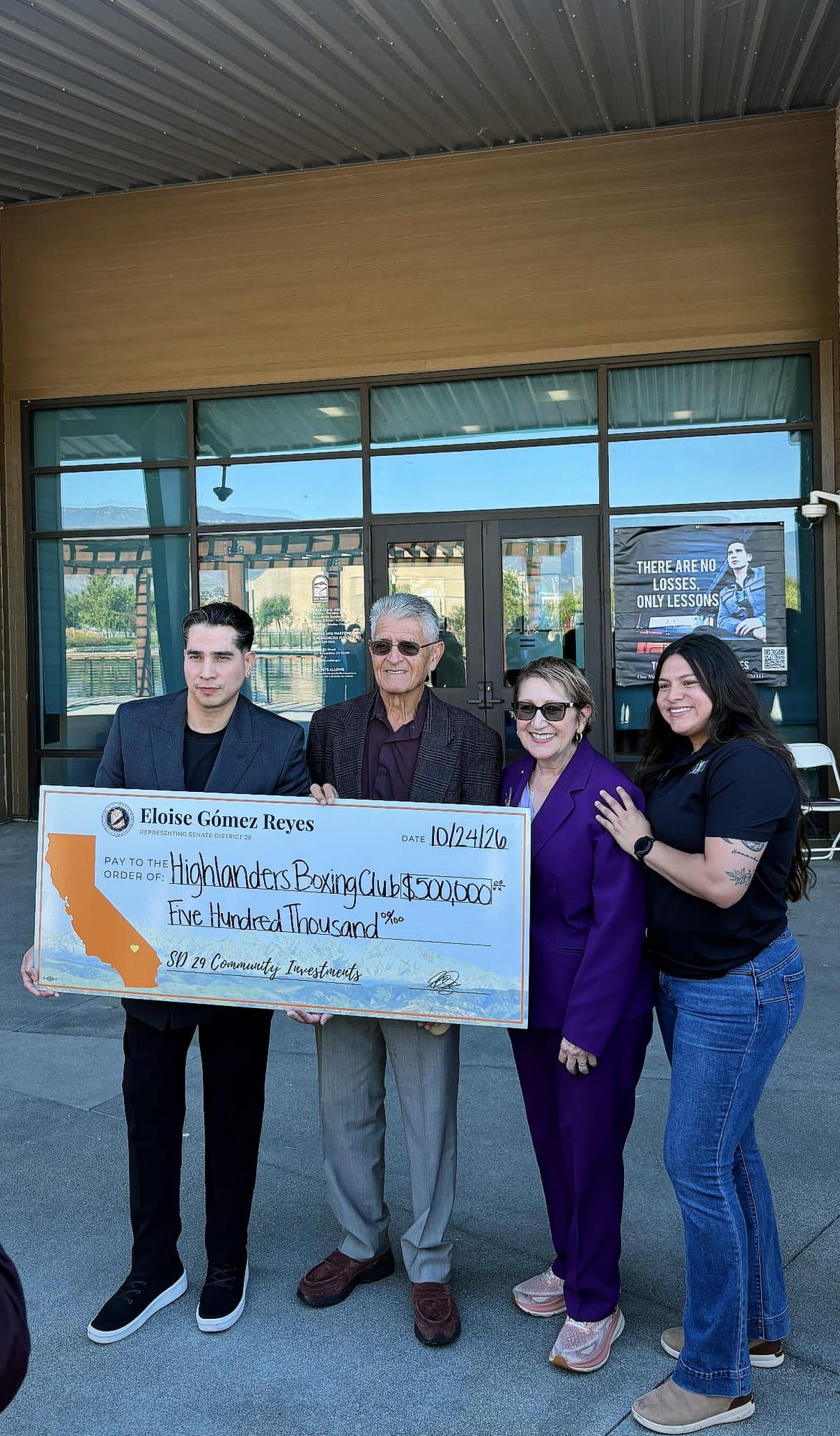 Group photo with a $500,000 check from Senator Eloise Gómez Reyes, Senate District 29, made out to Highlanders Boxing Club