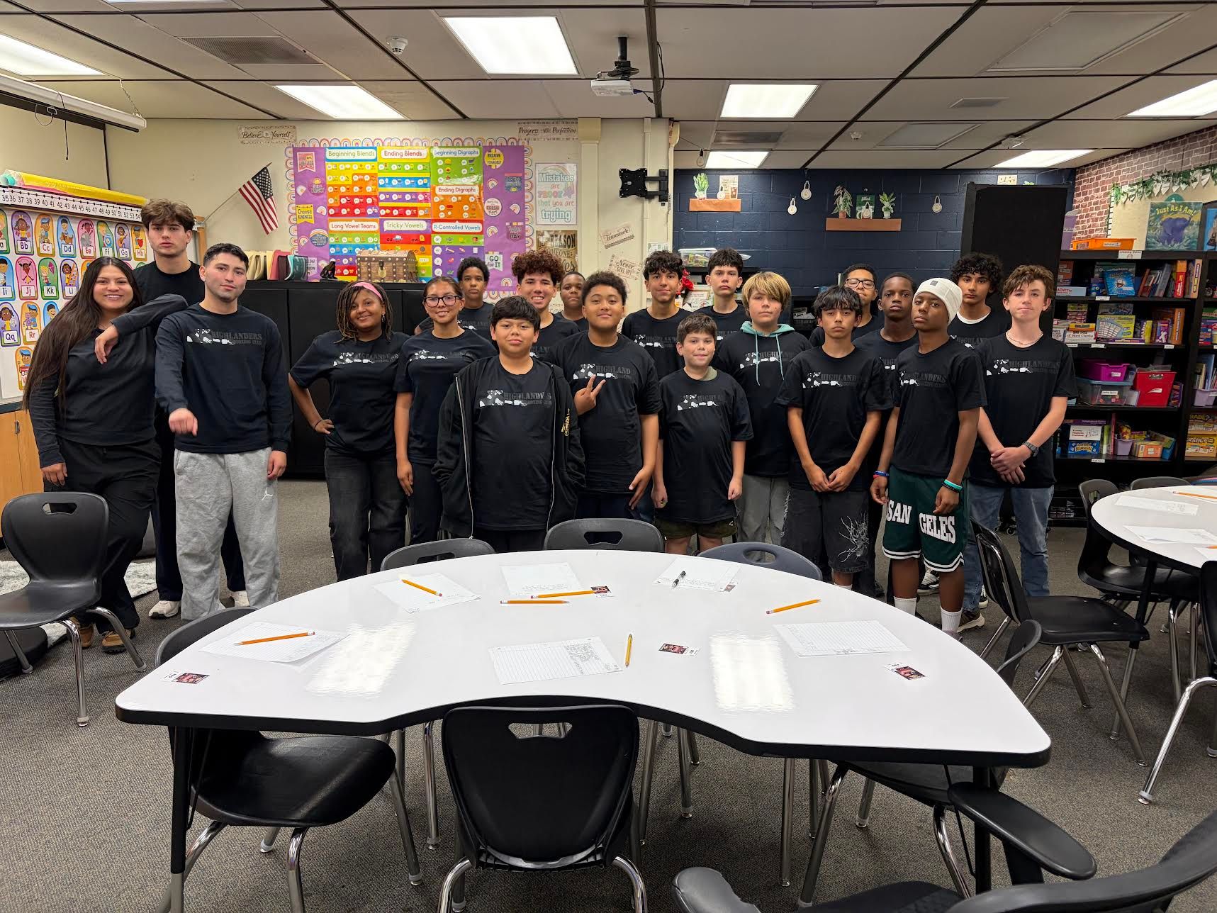 HBC coaches and mentors with SOAR Academy students in their HBC shirts, inside a San Bernardino school district classroom