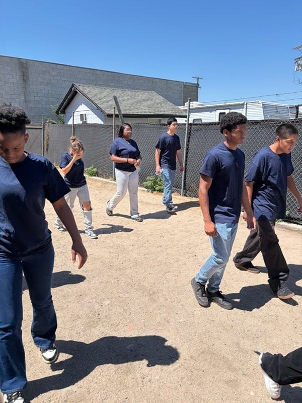 HBC summer camp youth walking through team fitness drills together in the training yard